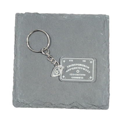 Ouija Board Keychain engraved on clear acrylic and displayed on a slate tile for contrast