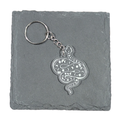 Large Celestial Snake Keychain engraved on clear acrylic and displayed on a slate tile for contrast