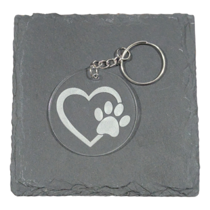 Heart with Paw Print engraved on acrylic keychain displayed on slate for contrast