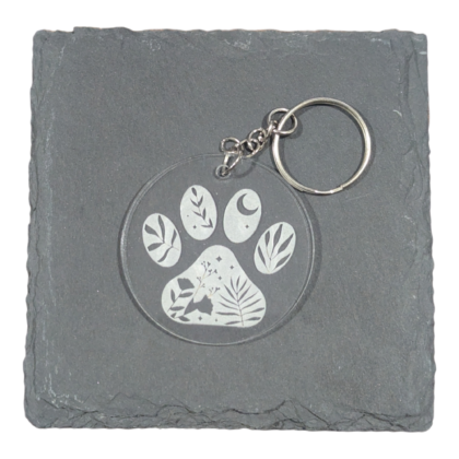 Floral Paw Print image engraved on clear acrylic keychain displayed on slate for contrast