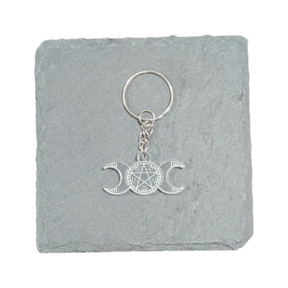 Triple Goddess Keychain engraved on clear acrylic and displayed on a slate tile for contrast